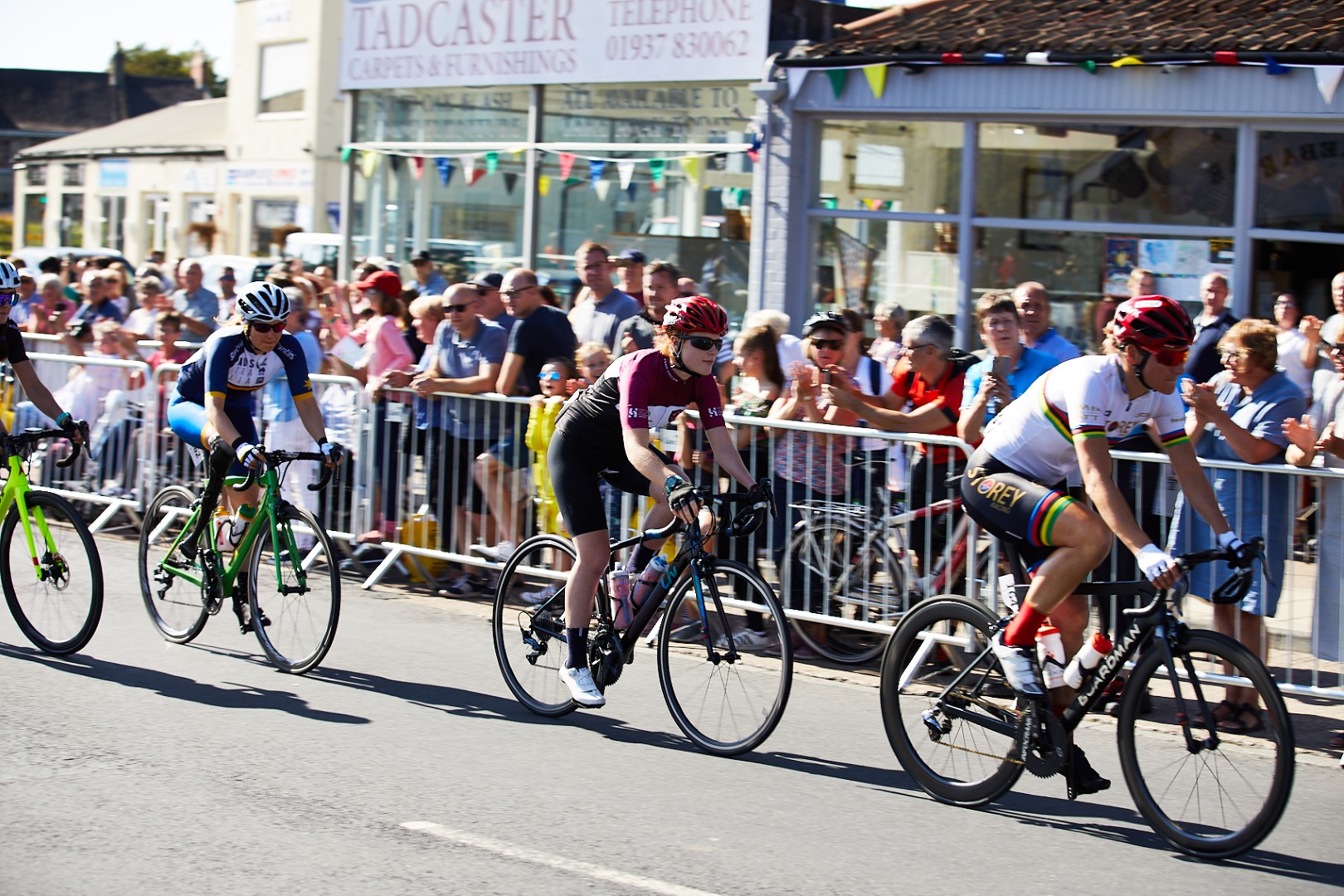 cyclists going past crowd